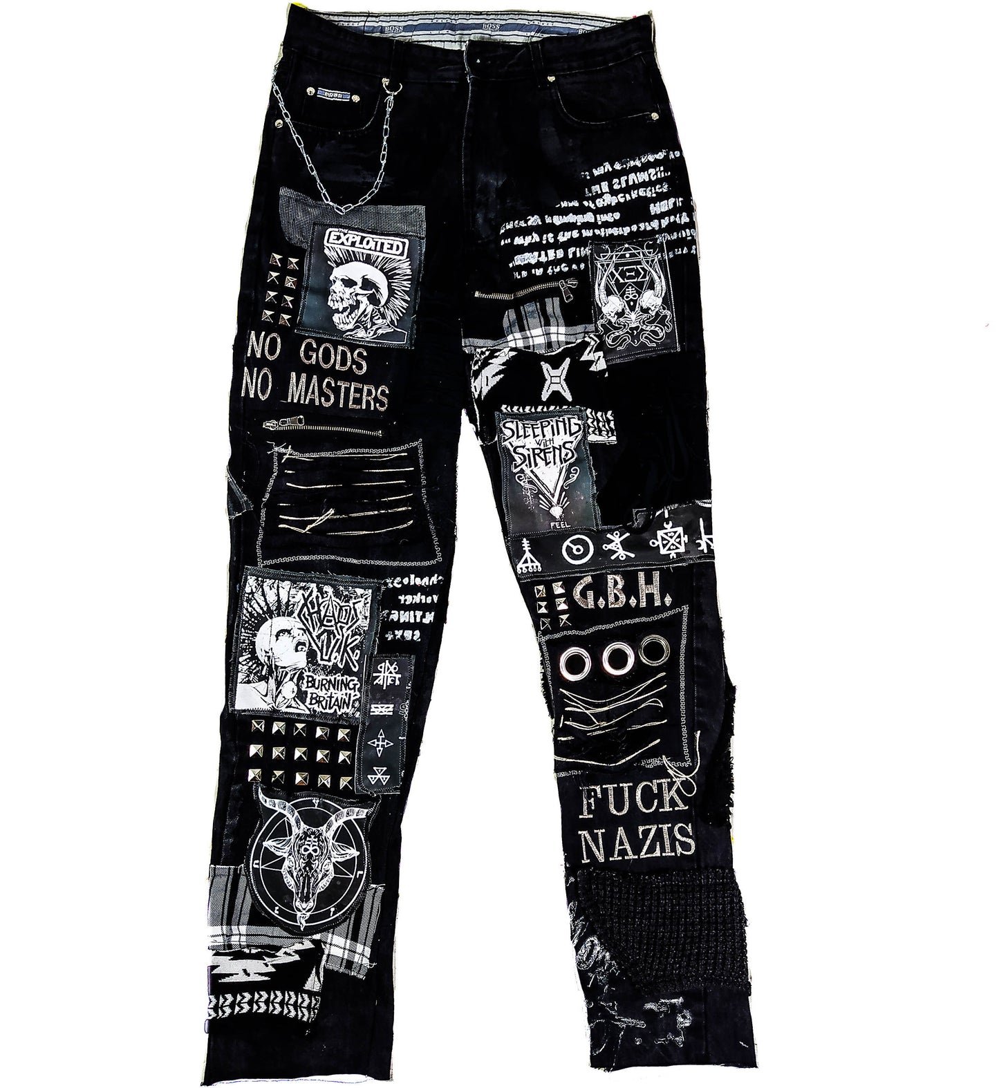 Flat laid black pair with embroideries such as no gods, no masters, prints with punk bands such as exploited, burning britain, sleeping with sirens along with studs, goat with horns, eyelets, laces, zippers, chain, abstract paint and patchwork.