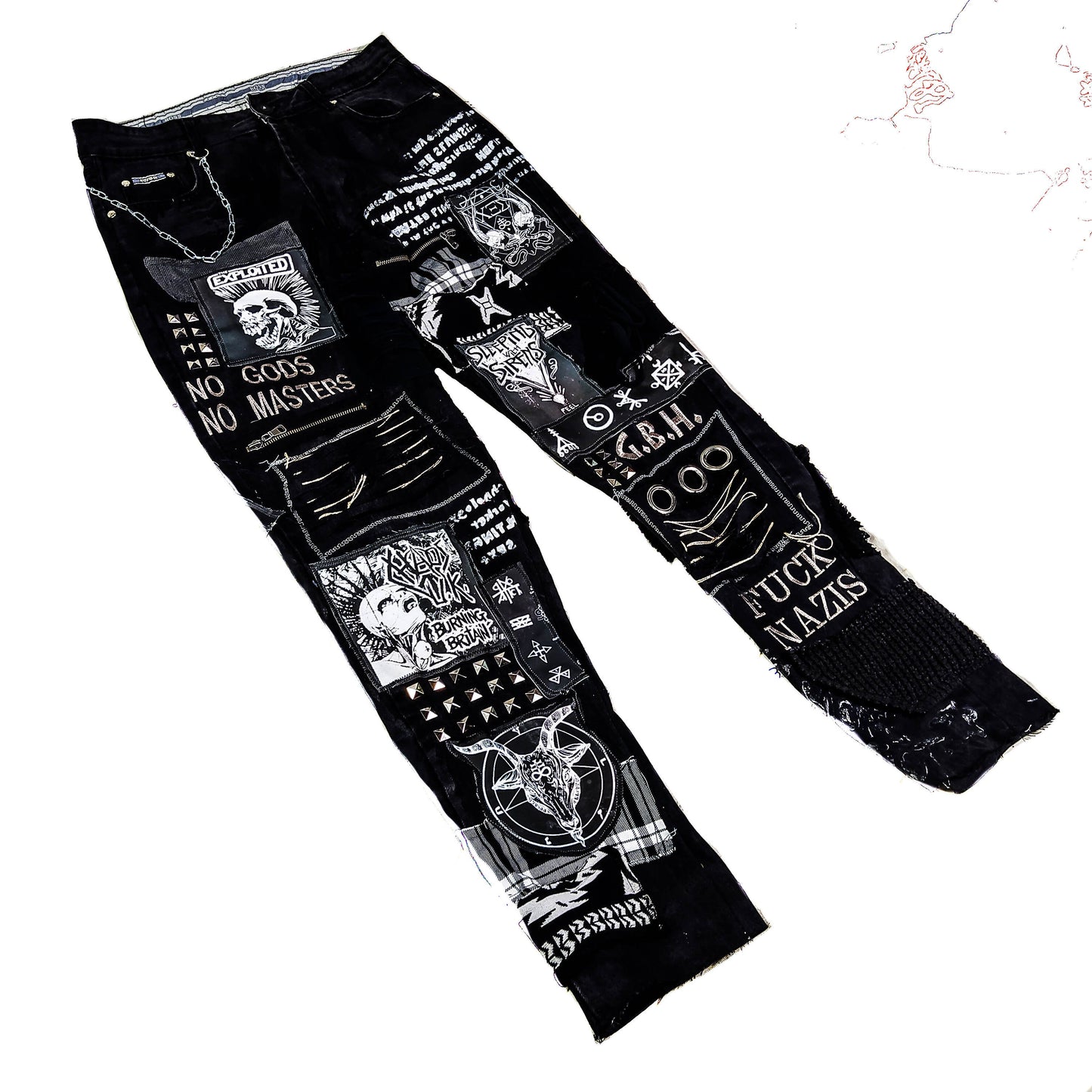 Flat laid black pair with embroideries such as no gods, no masters, prints with punk bands such as exploited, burning britain, sleeping with sirens along with studs, goat with horns, eyelets, laces, zippers, chain, abstract paint and patchwork.