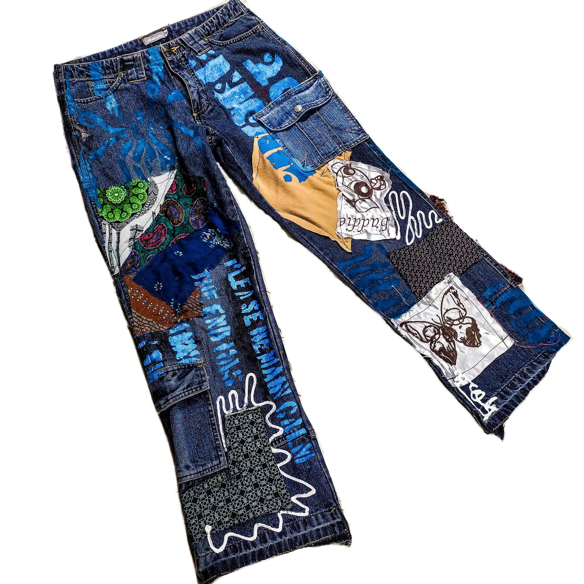 One of one blue pair of jeans containing abstract paintings and patchwork, embroidered powerpuff girls and a butterfly, tags and doodles.